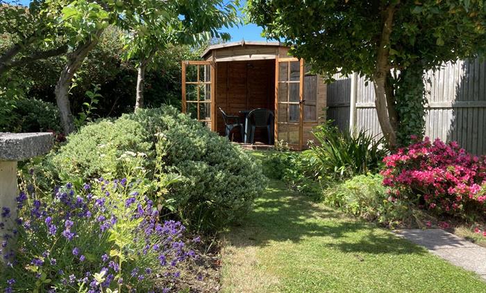 Landscaped gardens with summer house looking back over the garden and towards the mountains
